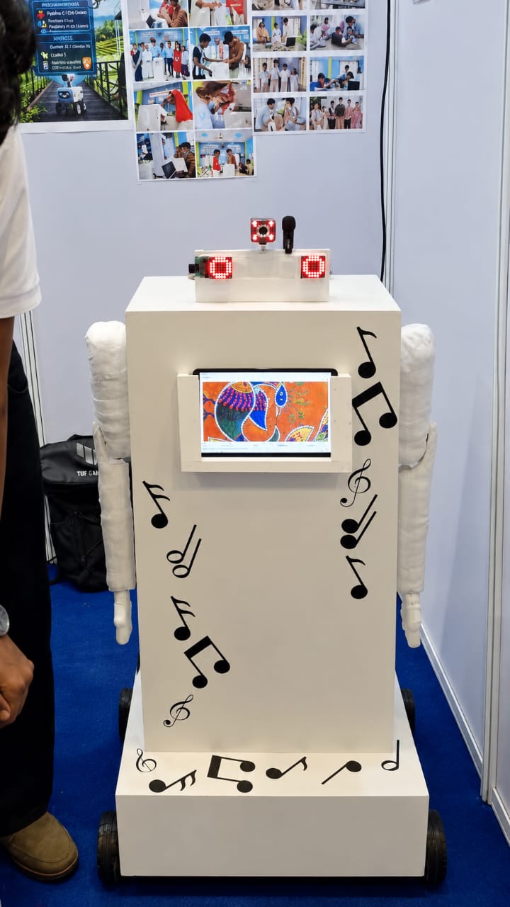 Keeper at Nationals: a tall white robot with red LED eyes, padded arms, music notes on its body and a screen showing a folk painting.